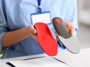 Custom arch support insoles displayed by healthcare specialist