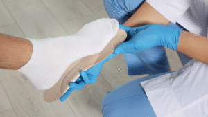 Podiatrist adjusting custom shoe insert to support patient’s foot arch